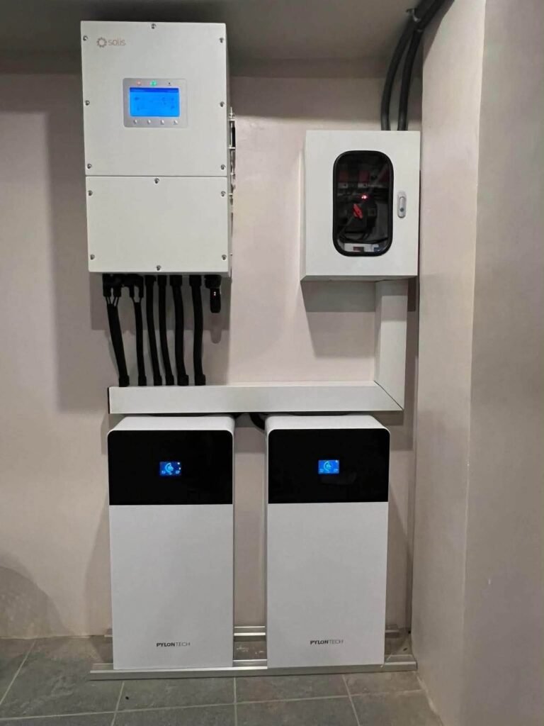 Technicians working on a stacked battery storage system