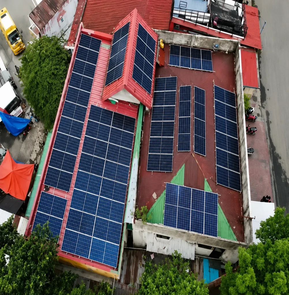 Solar panels covering the red roof of Subangdako Barangay Hall and Police Station